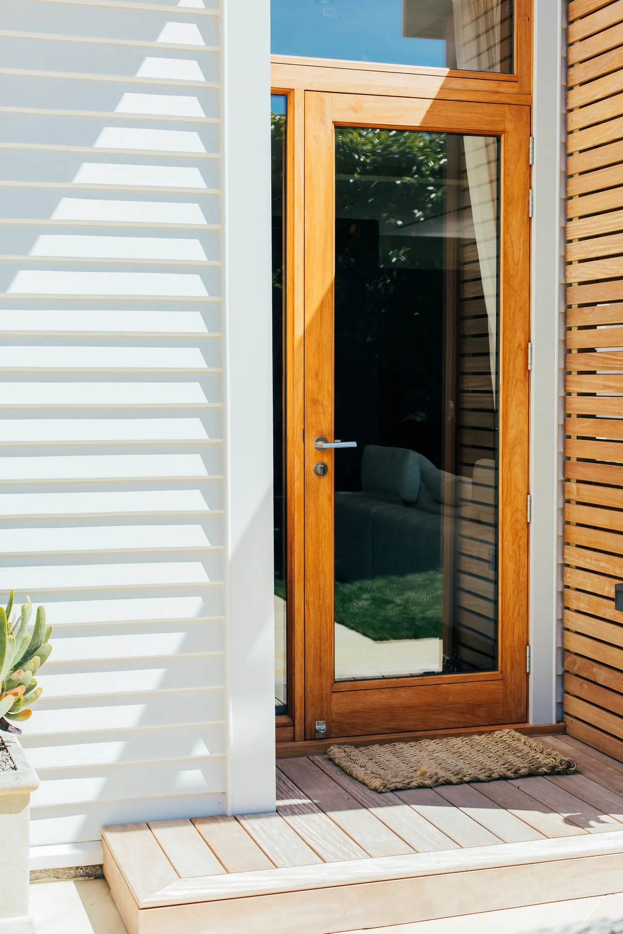 Timber back door and indoor-outdoor flow by Island Bay Builders